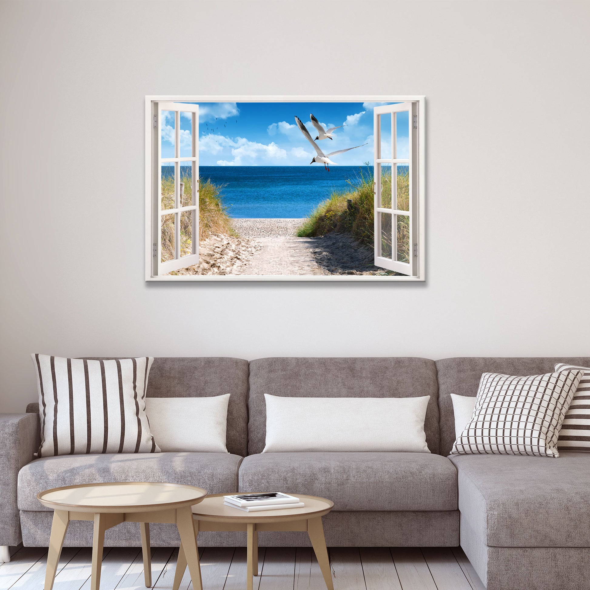 Wandgestaltung Wohnzimmer mit Leinwandbild Motiv Fensterblick auf Strand mit Möwen